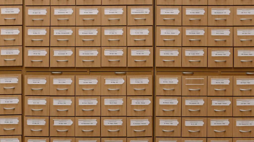 Rows of old metal filing cabinets in a dim office, representing a candidate database left to go out of date