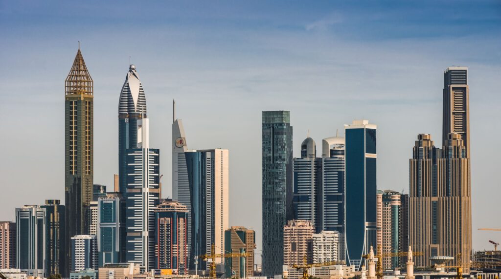 Office towers at dusk in a global business district, representing multi-office recruitment agency groups