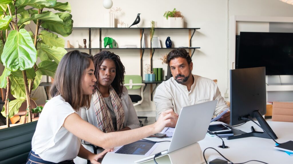 Recruitment agency team comparing recruitment CRM options in an office
