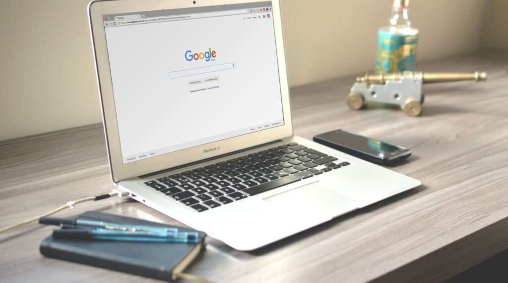 Recruiter reviewing a candidate profile on a laptop while a browser extension fails to sync data into the CRM
