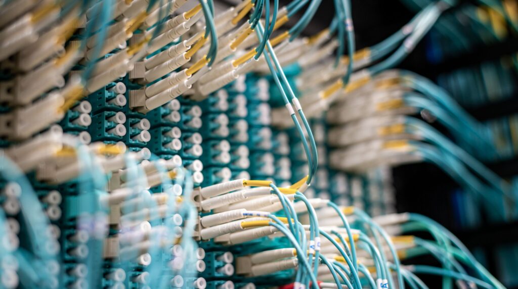 Neatly labeled network cables in a server rack, representing candidate data moving between recruitment systems
