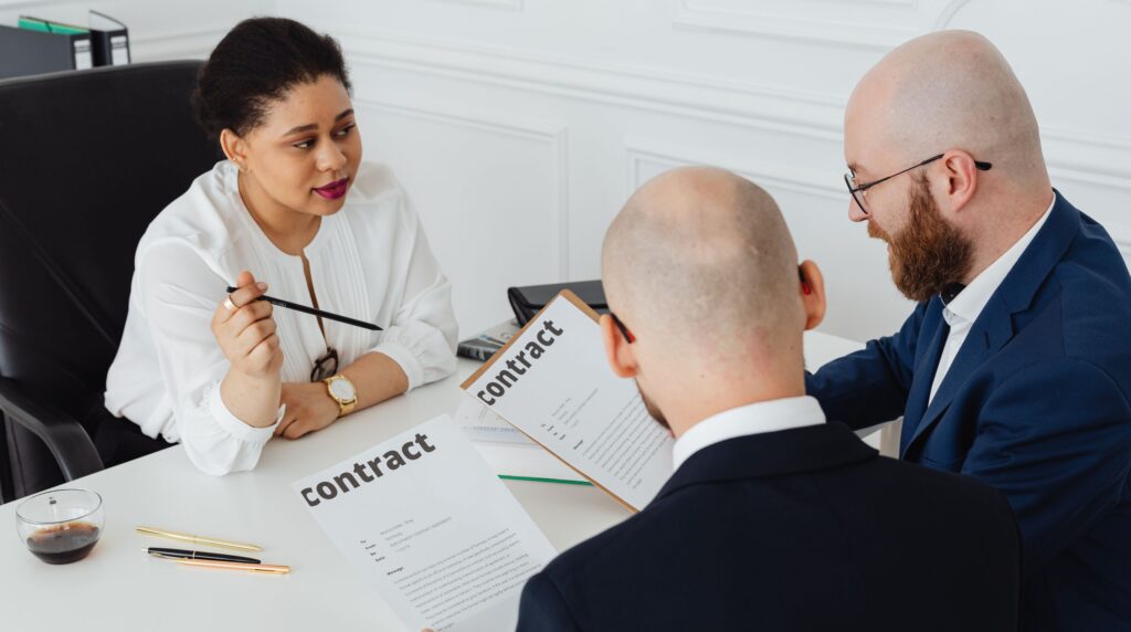 A recruitment agency director reviewing a software renewal contract at a desk