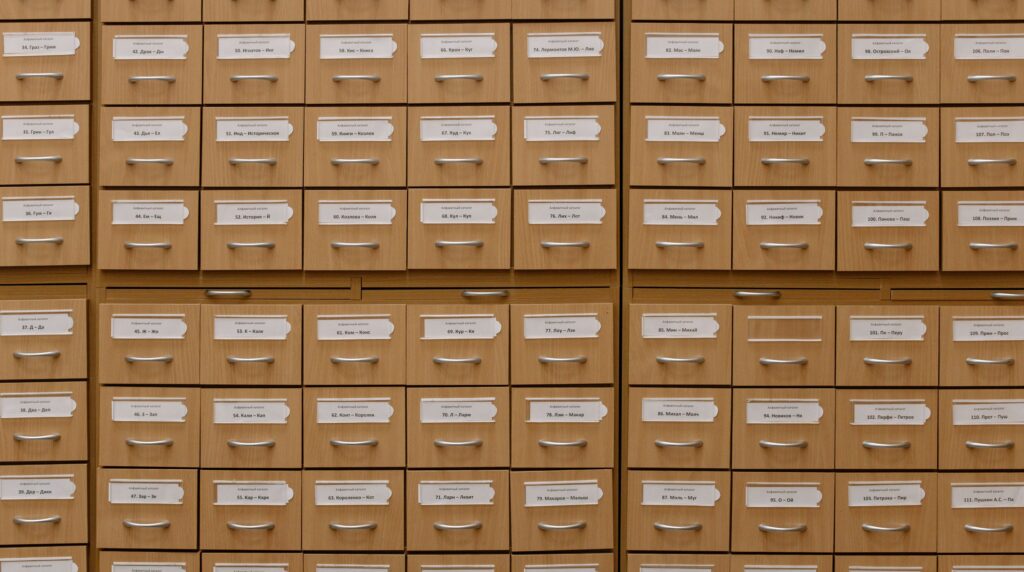 Rows of labeled index card drawers, illustrating the limits of searching candidates by job title