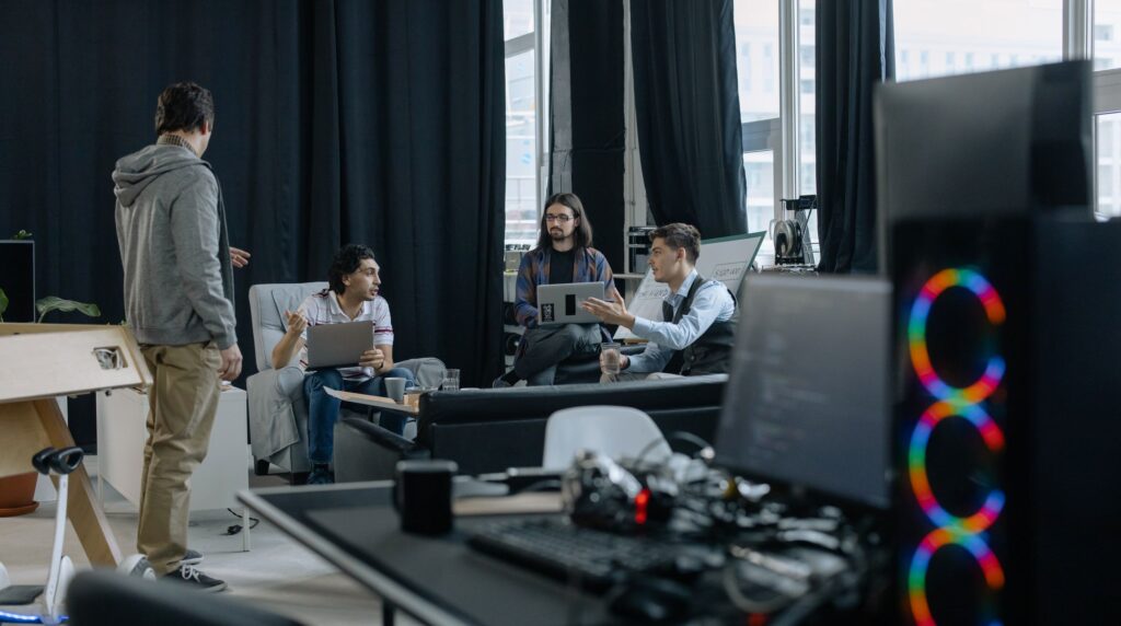 Recruitment agency decision makers reviewing CRM platform options on a laptop during a vendor demo